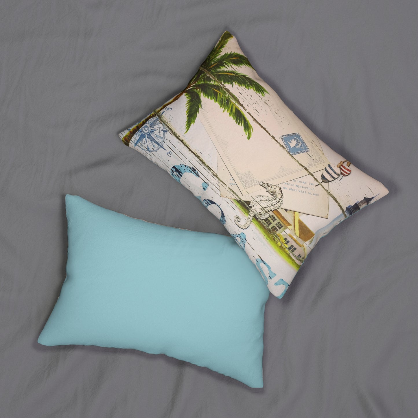 Two pillows on a gray surface, one turquoise and one with a tropical design.