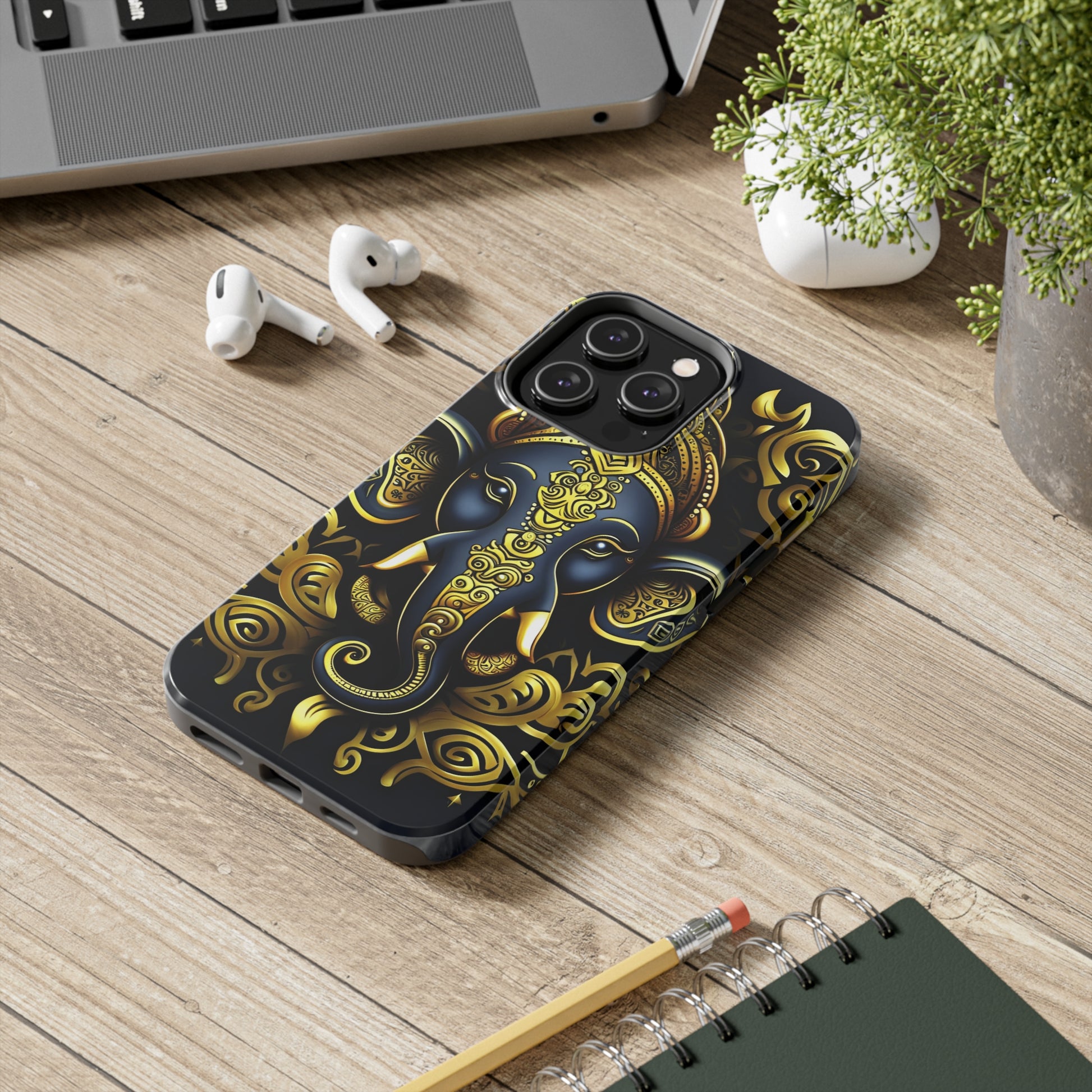 Tough Phone Case for iPhone 14  - Blue and Gold Ganesha Head Tribal Style Printed on Phone Case for iPhone 14 Pro Max on desk