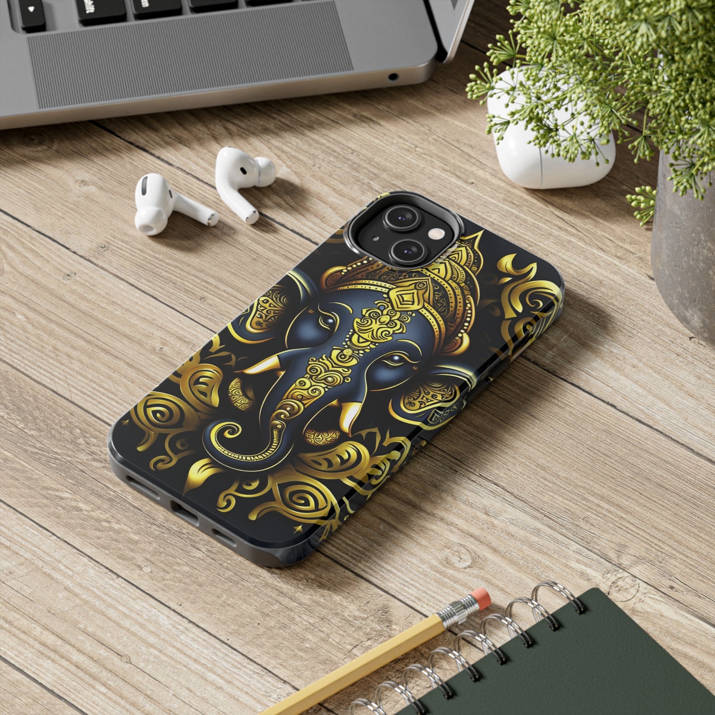 Tough Phone Case for iPhone 14  - Blue and Gold Ganesha Head Tribal Style Printed on Phone Case for iPhone 14 Plus on desk