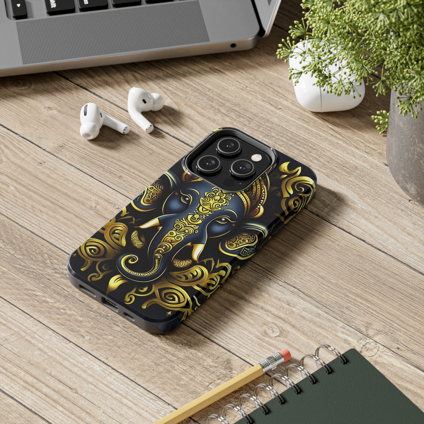 Tough Phone Case for iPhone 14  - Blue and Gold Ganesha Head Tribal Style Printed on Phone Case for iPhone 14 Pro on desk