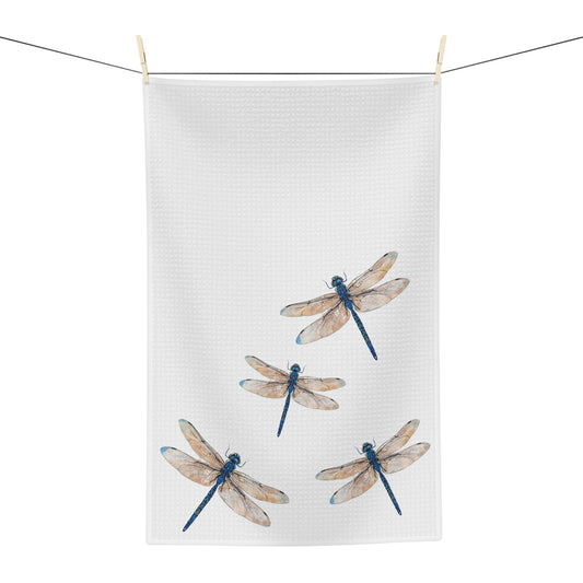 Tea towel with dragonfly design hanging on a line