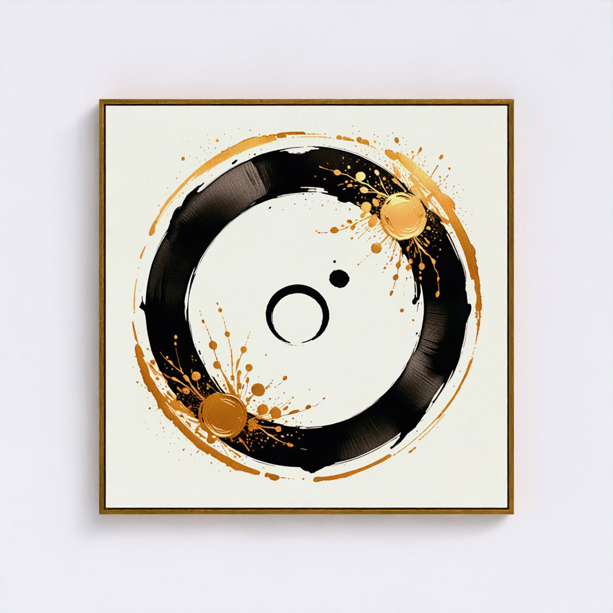 Square framed wall art featuring an abstract black circular brushstroke design with gold paint splatters on a cream background, shown hanging against a light gray wall.