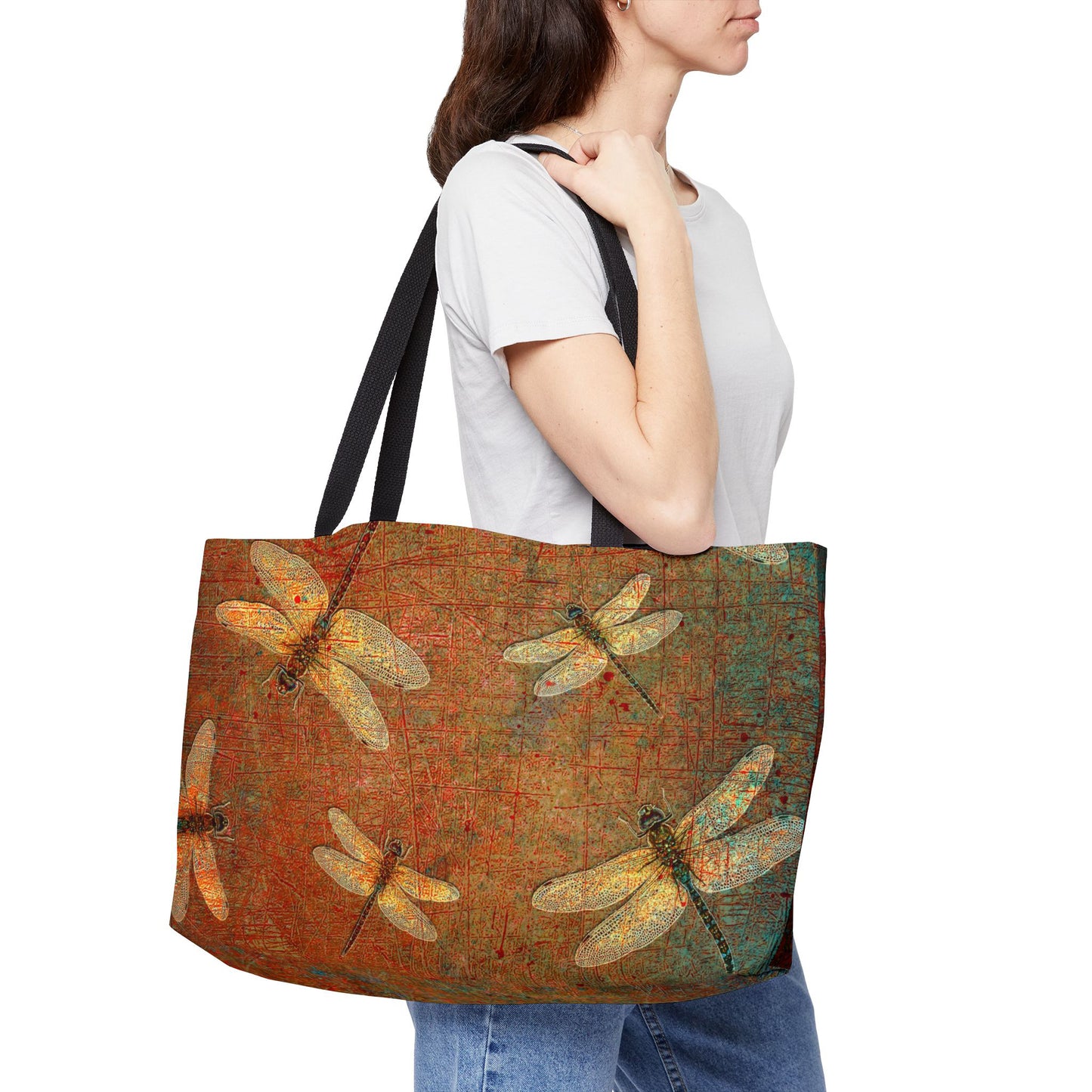 Woman carrying a tote bag with golden dragonflies design on a brown background
