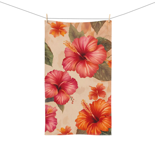 Floral towel with pink and orange flowers on a beige background, hanging on a line.