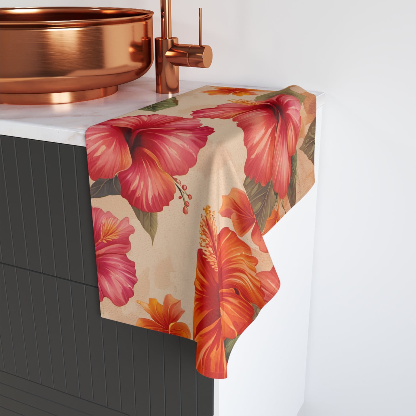 Floral tablecloth with pink and orange flowers draped over a table next to a copper faucet.
