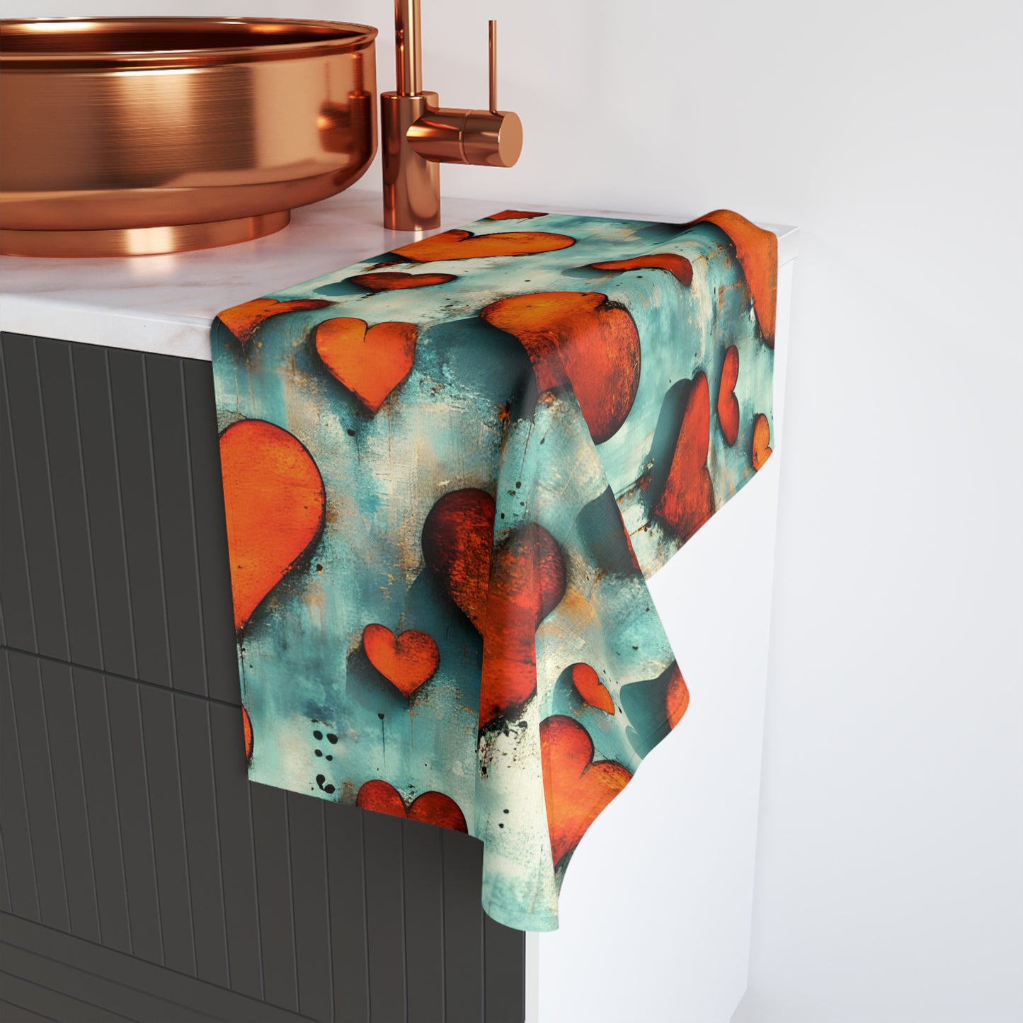 Towel with heart pattern hanging on a towel rack in a bathroom setting