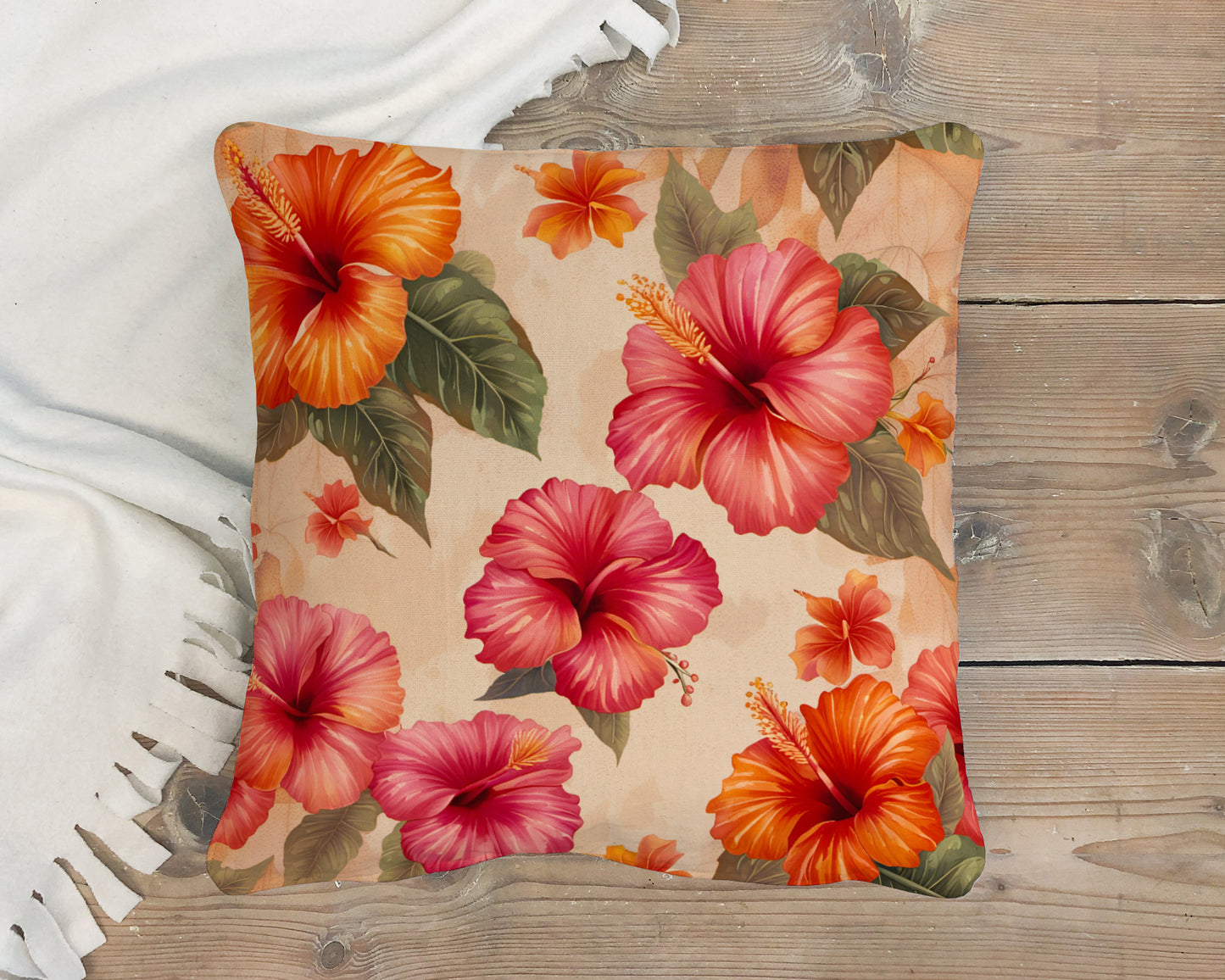 Floral-patterned pillow with orange and pink flowers on a wooden deck