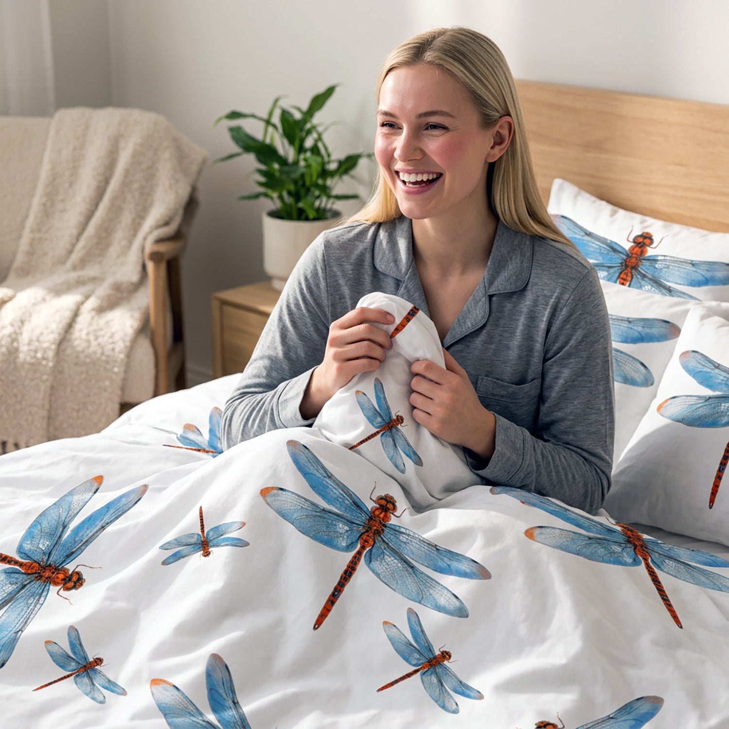 Woman holding a pillow with dragonfly design in a bedroom setting