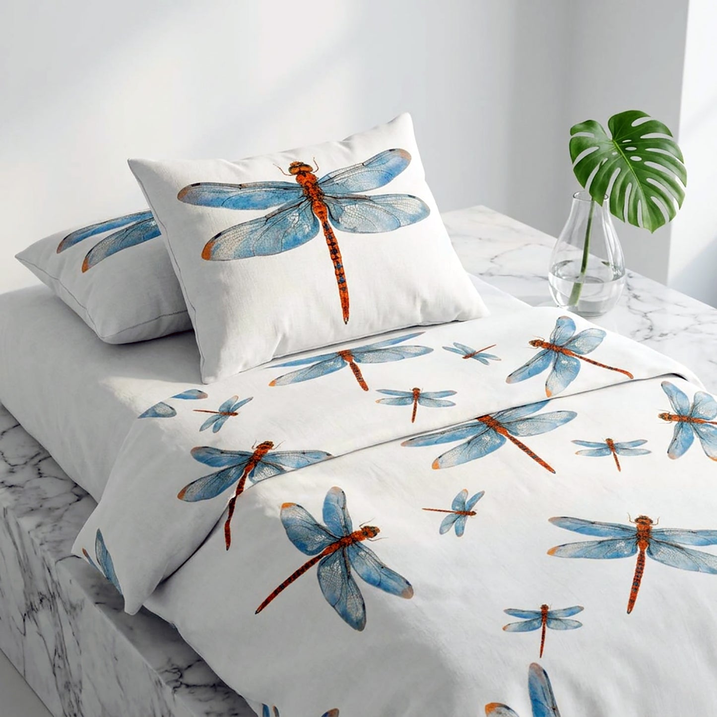 Dragonfly-patterned bedding set on a bed with a white pillow and marble surface.