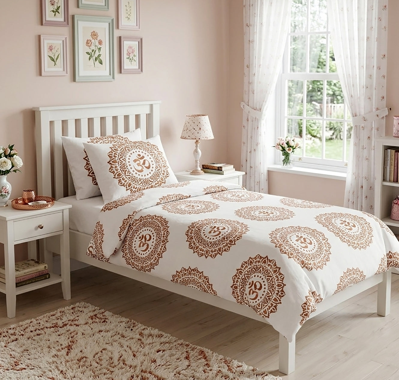 A white single bed dressed in a duvet cover and pillow sham set featuring a brown mandala pattern with Om symbols inside, styled in a soft pink bedroom with white furniture and a window.
