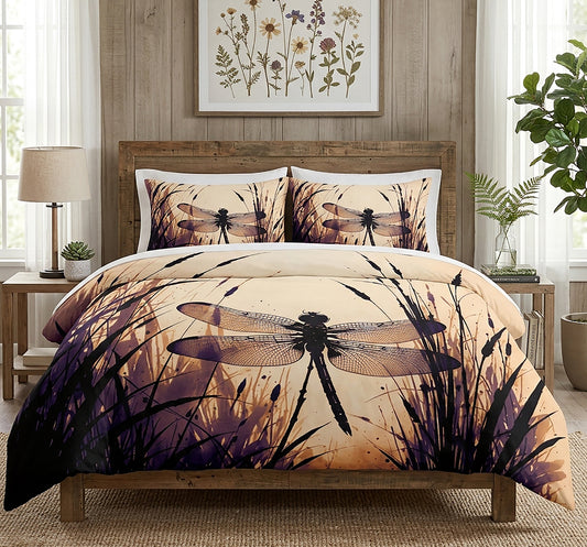 A bed dressed in a printed duvet cover and matching pillow shams featuring a large dragonfly over reeds in warm beige, brown, and purple tones, styled in a bedroom with wood headboard, bedside lamps, plants, and wall art.