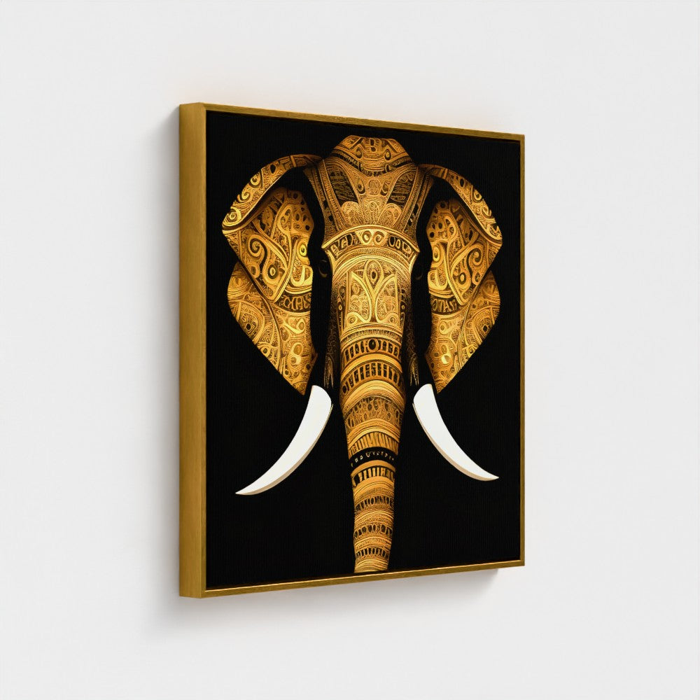 A framed wall art print featuring a stylized golden elephant head with white tusks on a black background, shown hanging against a light gray wall.
