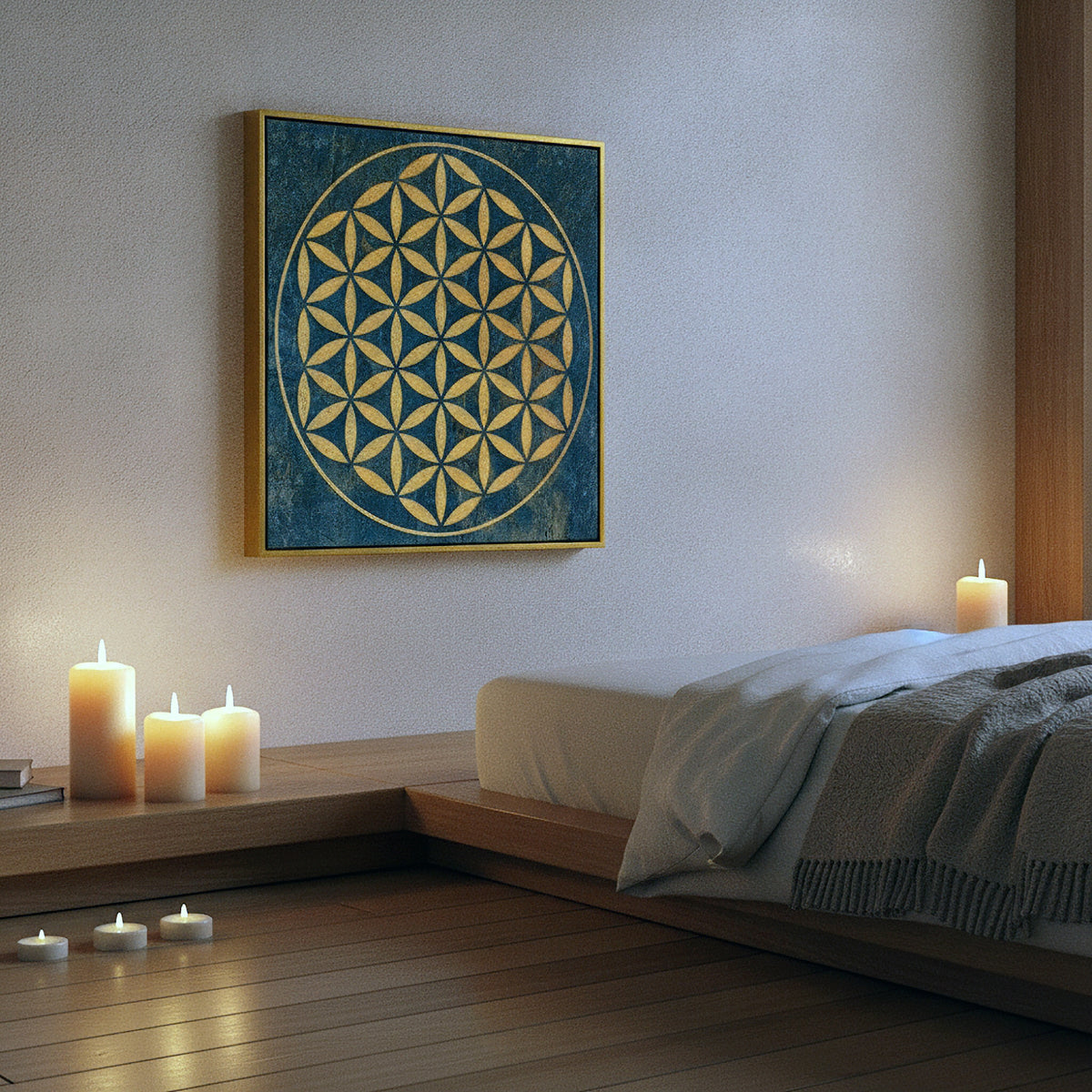 A square wall art print featuring a gold Flower of Life geometric design on a textured dark blue background, styled in a serene bedroom setting above a low wooden platform with lit candles.