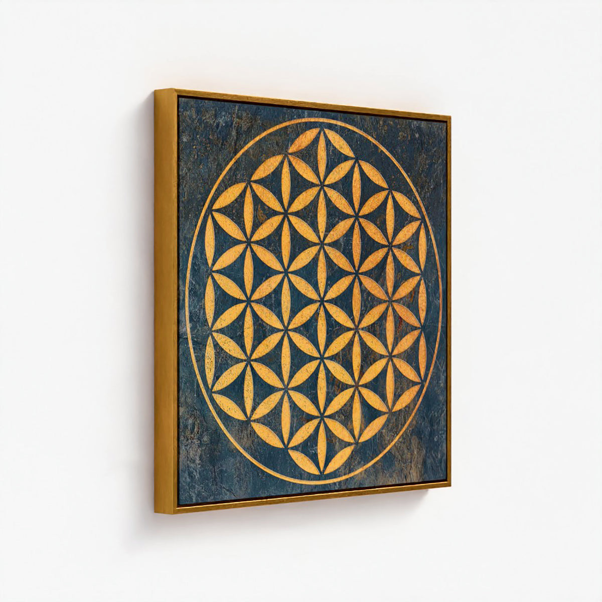 Framed canvas wall art featuring a golden geometric flower design on a dark textured blue background, shown hanging on a plain white wall.