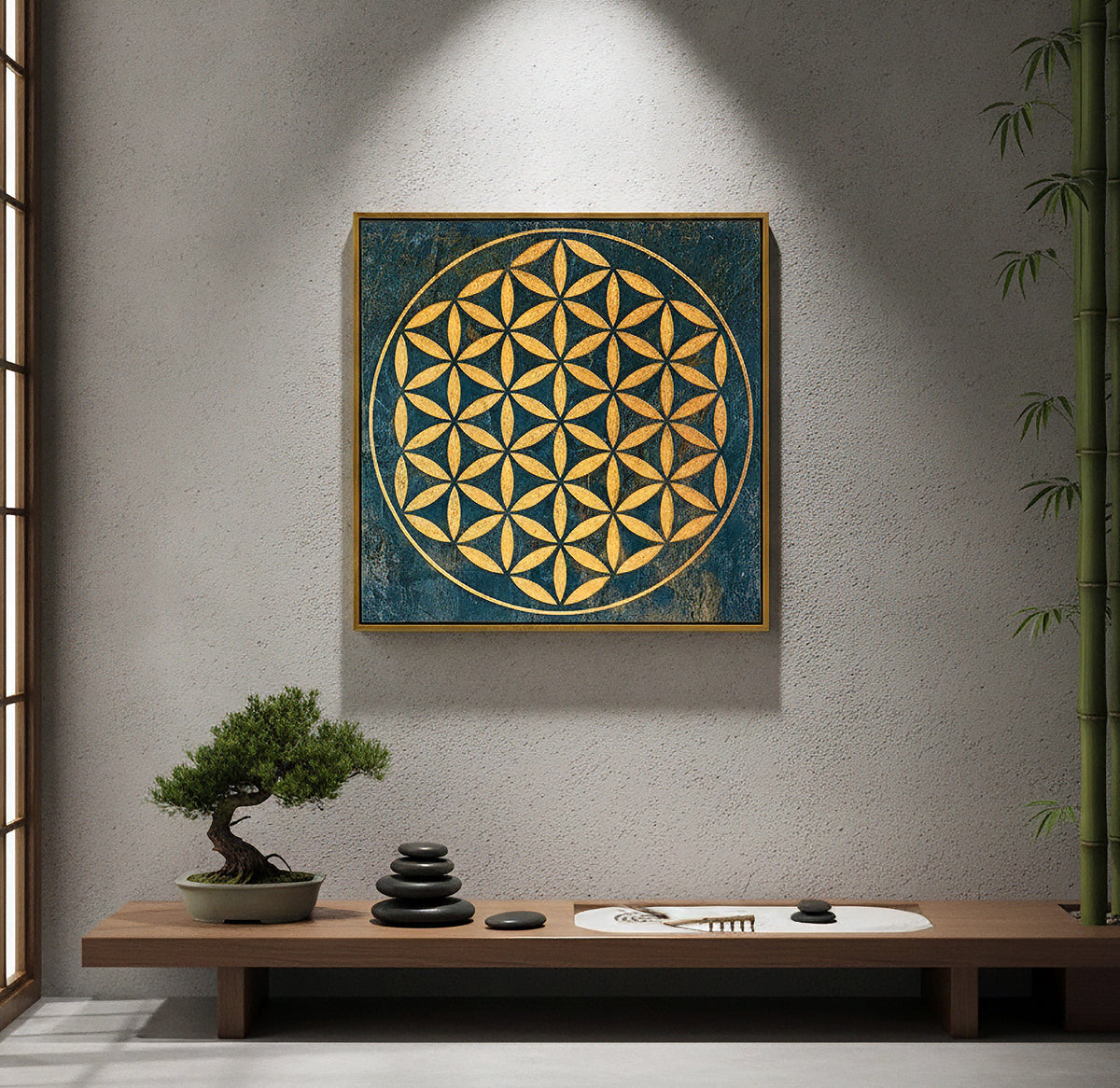 Square framed wall art featuring a gold geometric flower-of-life pattern on a dark blue textured background, displayed on a textured gray wall above a wooden bench with a small bonsai tree and zen stones.
