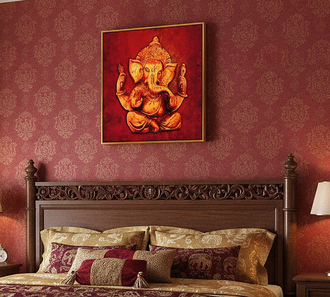 A framed wall art piece depicting a golden Ganesha on a deep red background, hung above a dark carved wooden bed headboard against a patterned burgundy wallpaper.