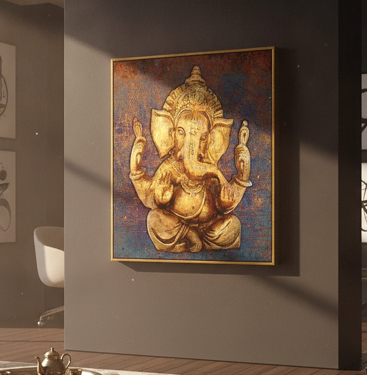 A square framed wall art print depicting a golden Ganesha figure against a textured blue and brown background, hanging on a dark gray wall in a modern interior setting.