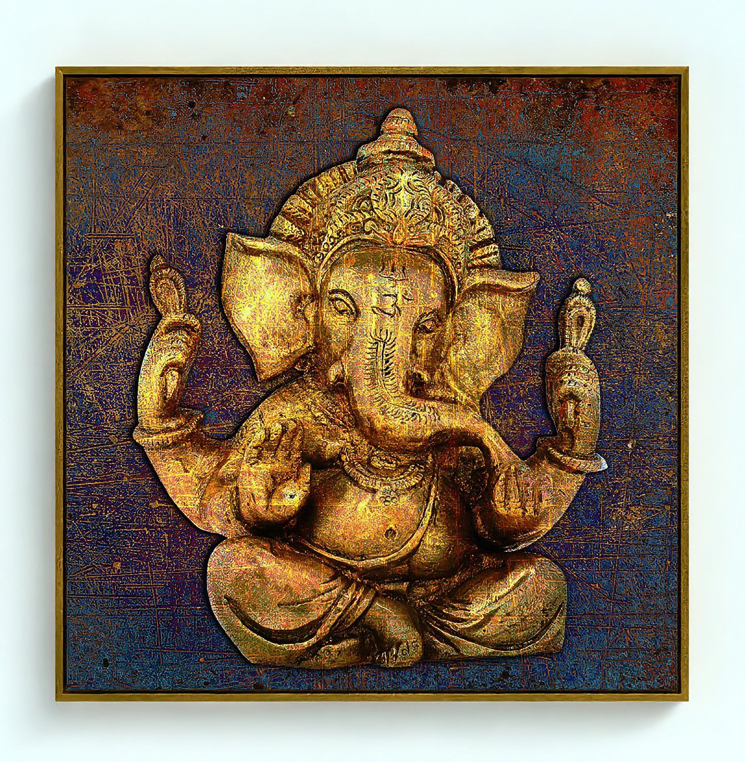 A square framed wall art piece featuring a golden Ganesha sculpture against a textured dark blue and brown background, shown hanging on a light wall.