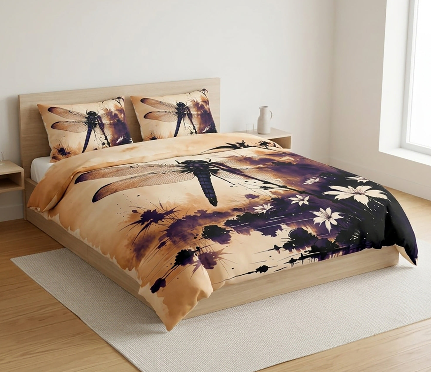A bedding set featuring a duvet cover and two pillowcases with a dragonfly and floral watercolor design, displayed on a wooden bed frame in a bright, modern bedroom.