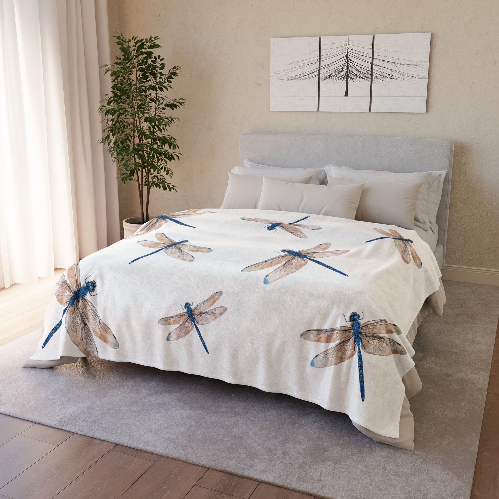 A white duvet cover with a pattern of blue and brown dragonflies, styled on a bed in a modern, neutral-toned bedroom.
