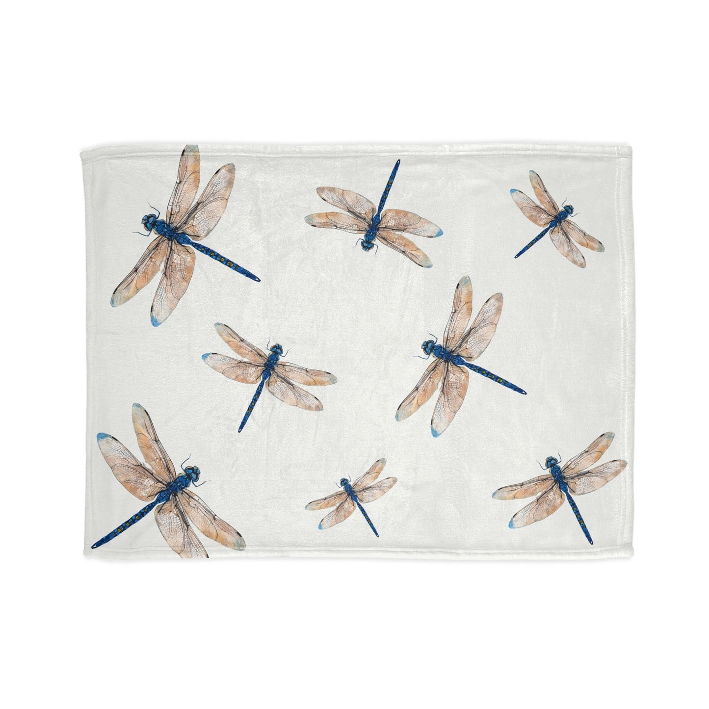 A rectangular white towel or blanket featuring a watercolor-style print of dragonflies in blue and beige, shown flat against a white background.