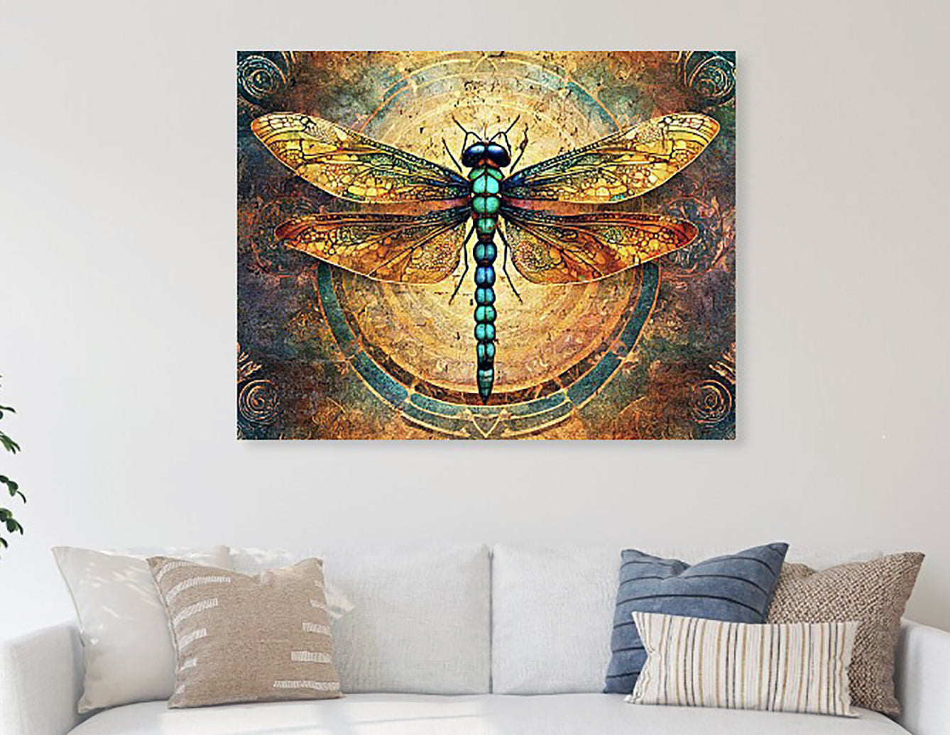metal print of a dragonfly on a decorative wall above a sofa.