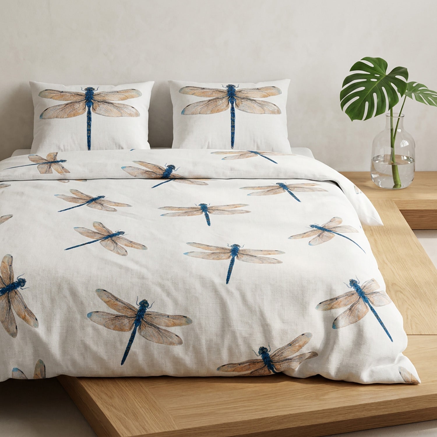 Dragonfly-patterned bedding set on a bed with a plant in the background