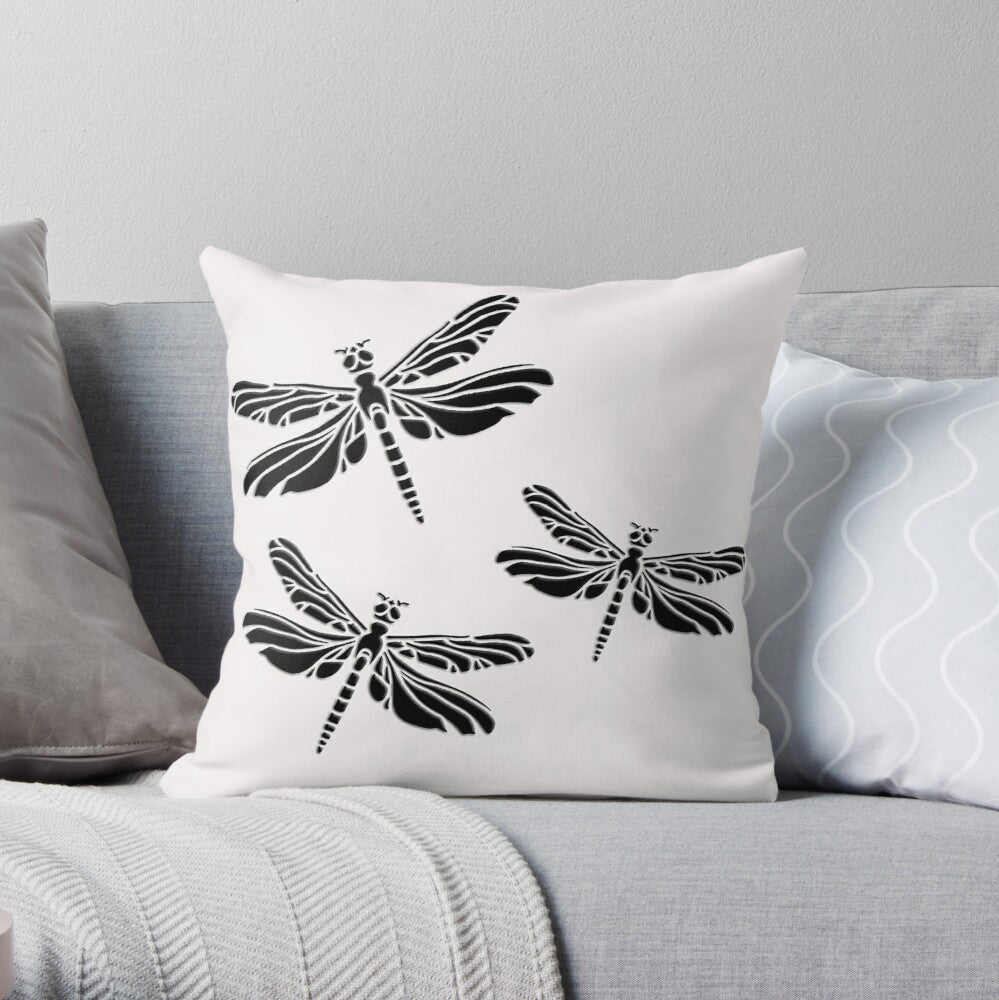 Minimalist square white pillow with 3 black Dragonflies on sofa